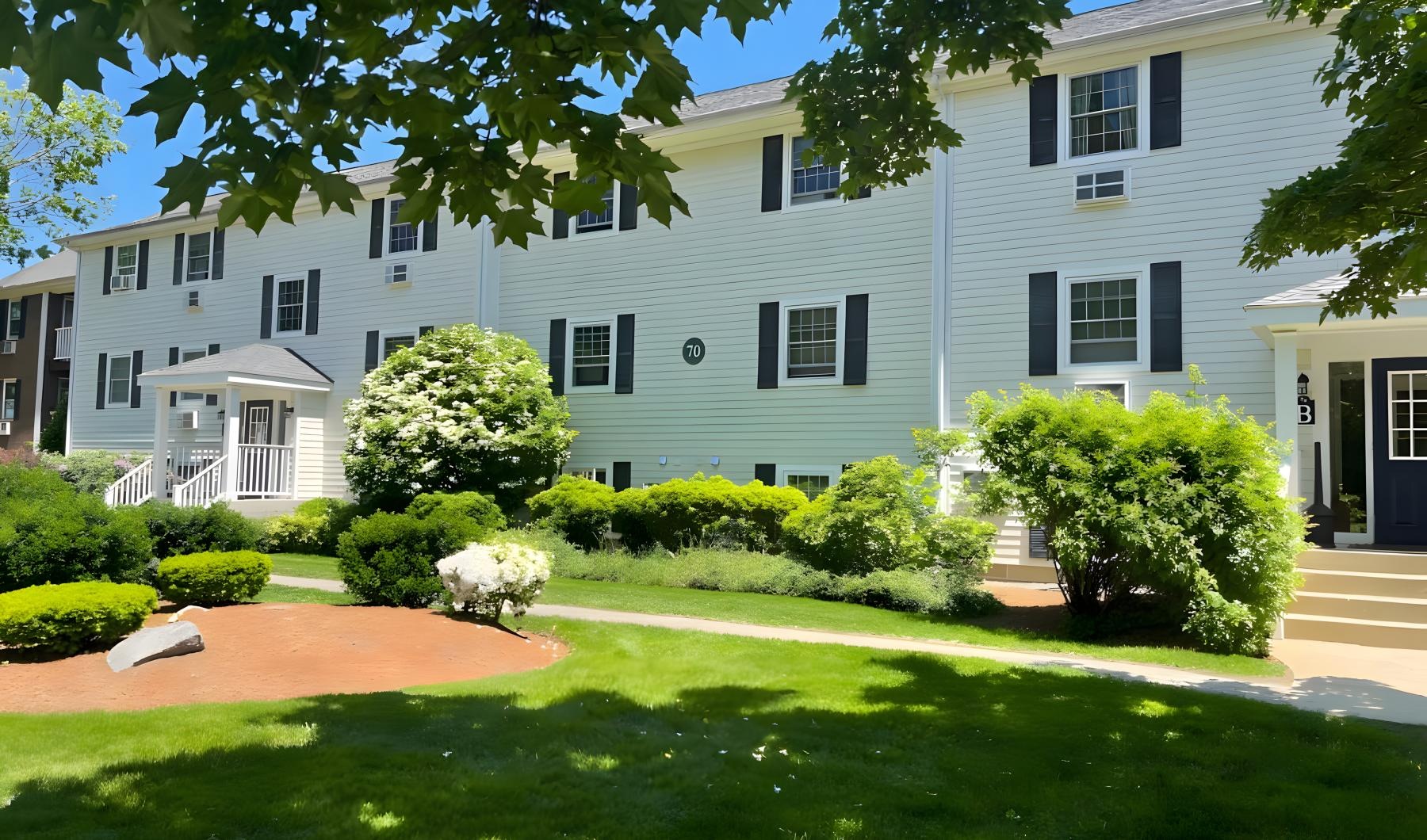 a large white house with a lawn