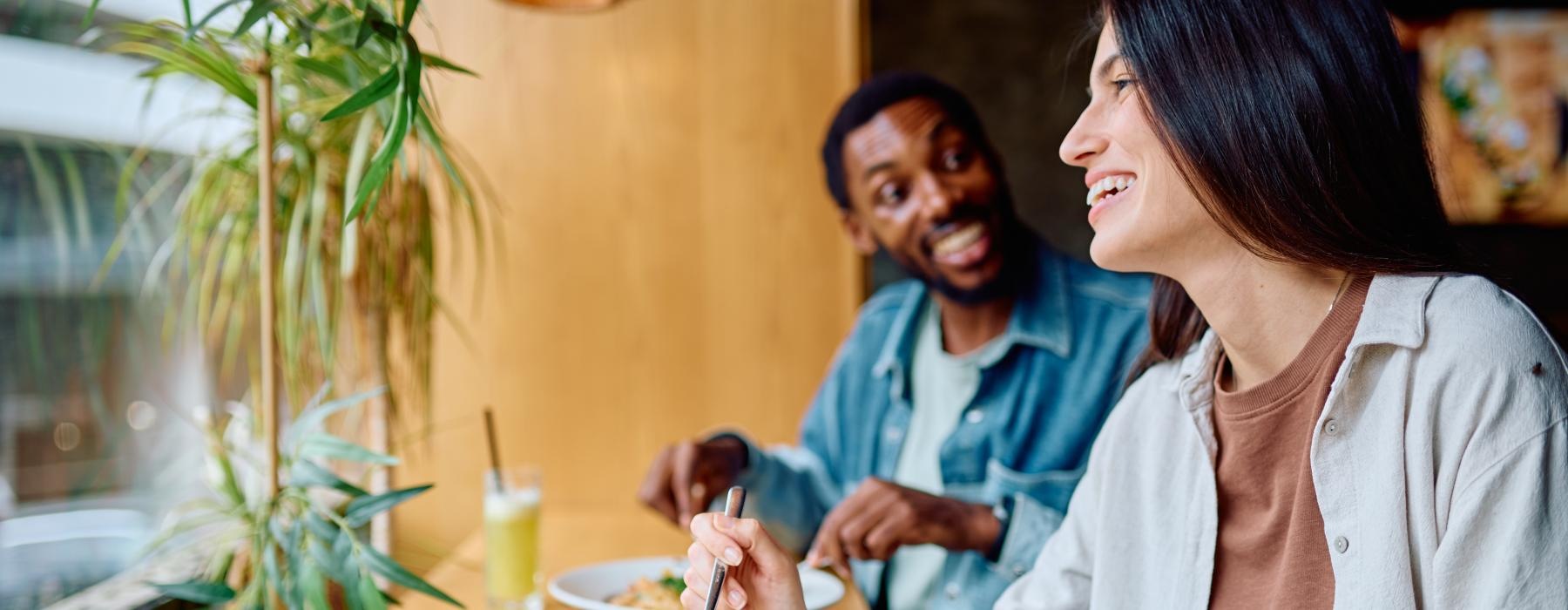 a man and woman eating at a table