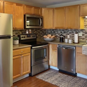 a kitchen with wooden cabinets