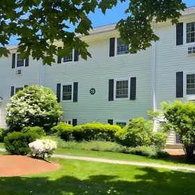 a large white house with a lawn